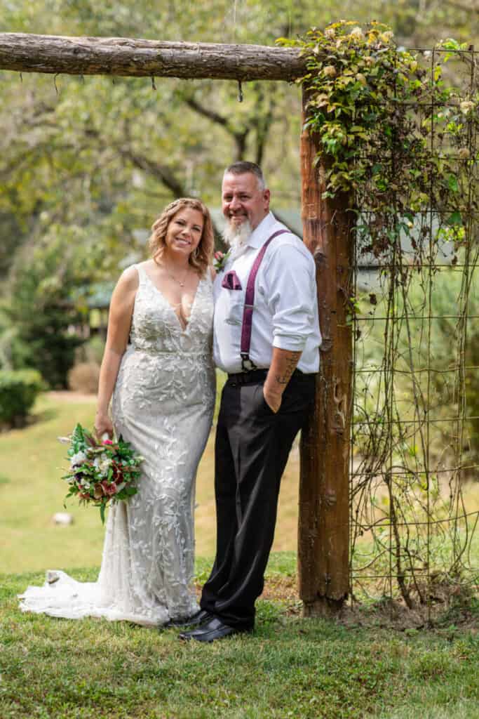 elopement bride and groom under wooded arbor
